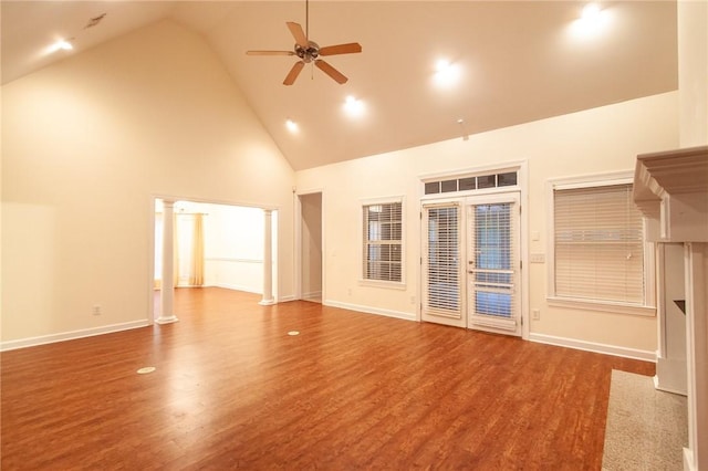 unfurnished room with ceiling fan, french doors, high vaulted ceiling, and hardwood / wood-style flooring