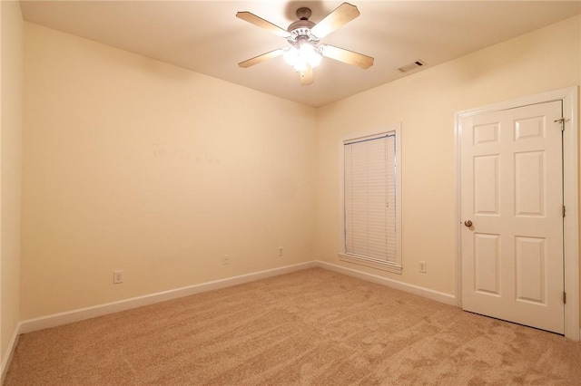 spare room with light carpet and ceiling fan