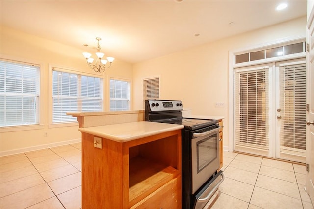 kitchen featuring stainless steel range with electric cooktop, hanging light fixtures, light tile patterned floors, and an inviting chandelier