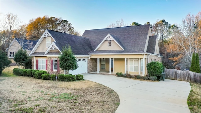 view of front facade featuring covered porch and a garage