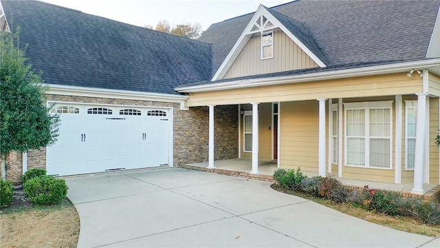 view of front facade with a porch and a garage