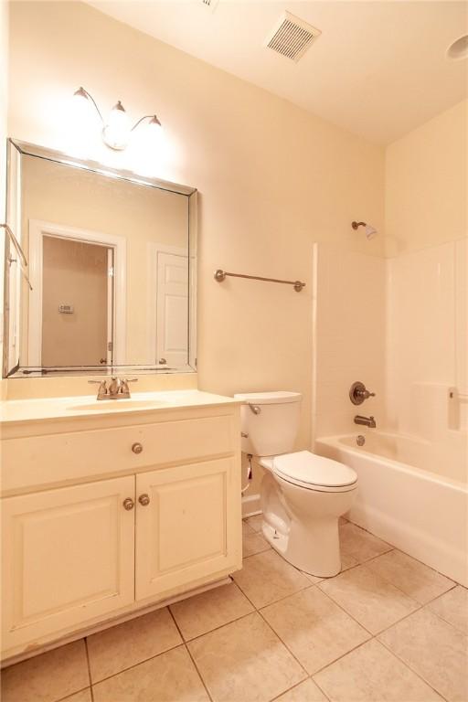 full bathroom with tile patterned floors, vanity, toilet, and tub / shower combination