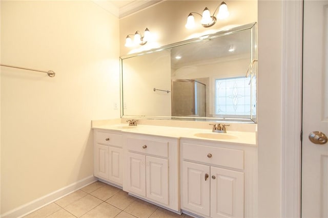 bathroom featuring tile patterned flooring, vanity, a shower with shower door, and ornamental molding