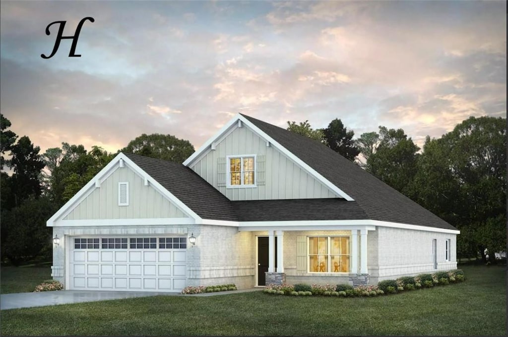 view of front of house with a yard and a garage