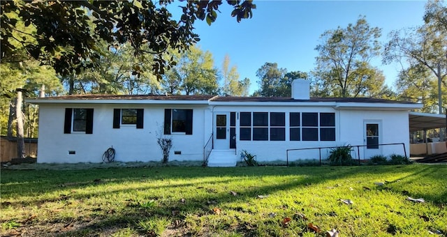 rear view of house with a yard and a carport