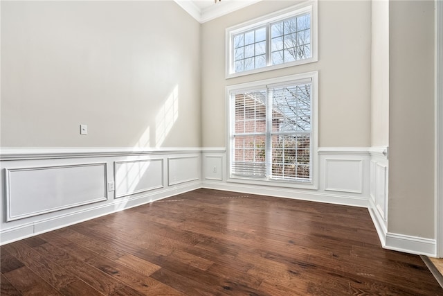 empty room featuring hardwood / wood-style flooring and ornamental molding