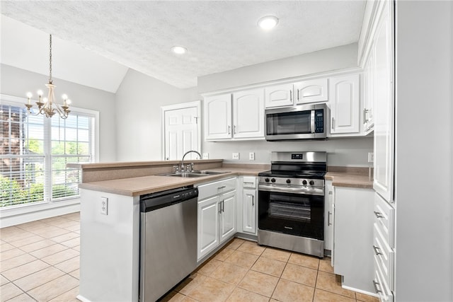 1848 Shadow Bend Ln, Auburn, AL 36830 - kitchen featuring a sink, light tile patterned floors, vaulted ceiling, and stainless steel appliances