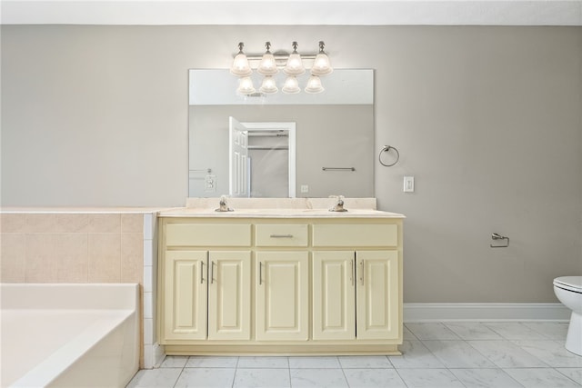 bathroom featuring vanity, toilet, and a tub