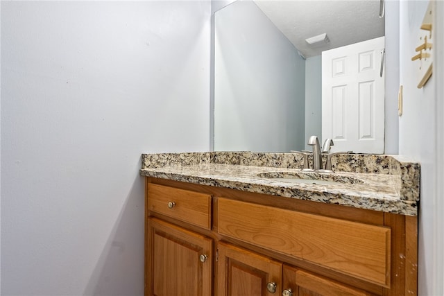 bathroom with vanity and a textured ceiling