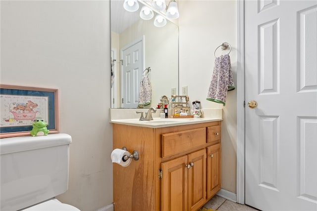 bathroom featuring tile patterned floors, vanity, and toilet