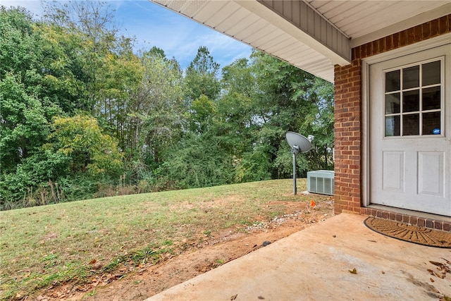 view of yard with central AC unit and a patio area