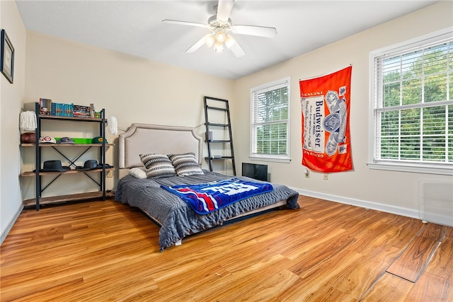 bedroom with hardwood / wood-style floors and ceiling fan