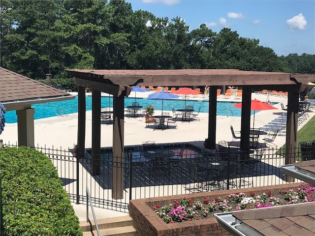 pool featuring a patio area and fence