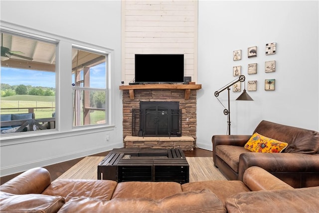 197 Westover St, Auburn, AL 36832 - living area featuring a stone fireplace, wood finished floors, and baseboards