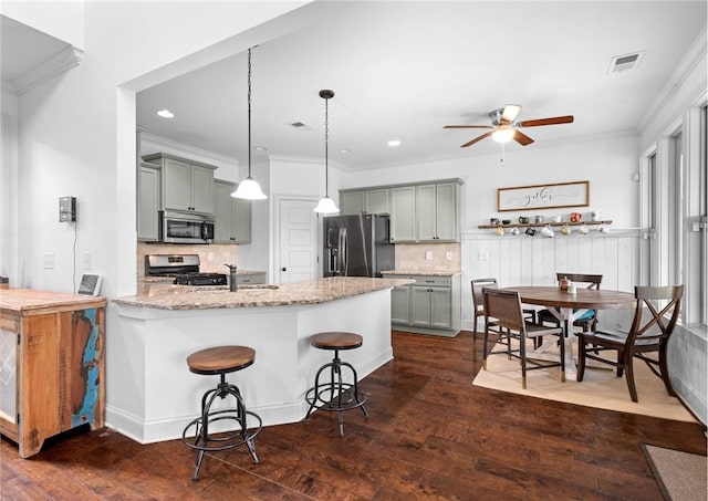 197 Westover St, Auburn, AL 36832 - kitchen with stainless steel appliances, gray cabinetry, a ceiling fan, a peninsula, and tasteful backsplash