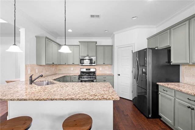 197 Westover St, Auburn, AL 36832 - kitchen featuring stainless steel appliances, gray cabinetry, a sink, a peninsula, and crown molding