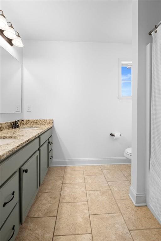 197 Westover St, Auburn, AL 36832 - bathroom with double vanity, toilet, and baseboards
