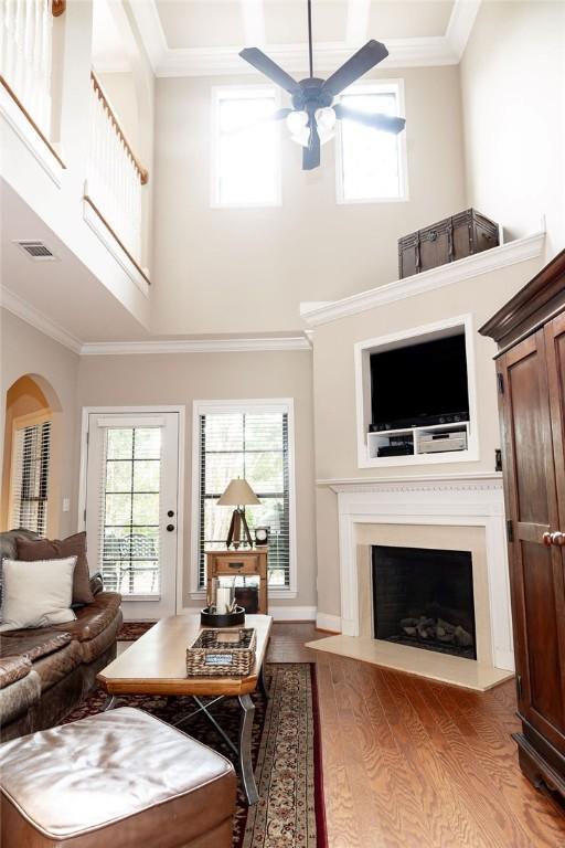1986 Stephanie Ct Unit Lt64, Auburn, AL 36830 - living area featuring ceiling fan, wood finished floors, a towering ceiling, a fireplace, and crown molding