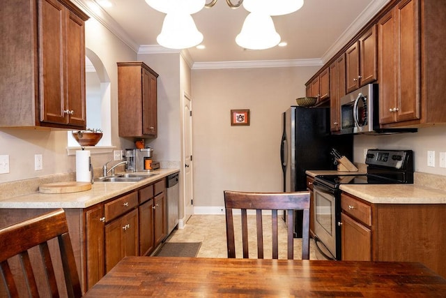 1986 Stephanie Ct Unit Lt64, Auburn, AL 36830 - kitchen featuring stainless steel appliances, light countertops, brown cabinetry, and crown molding