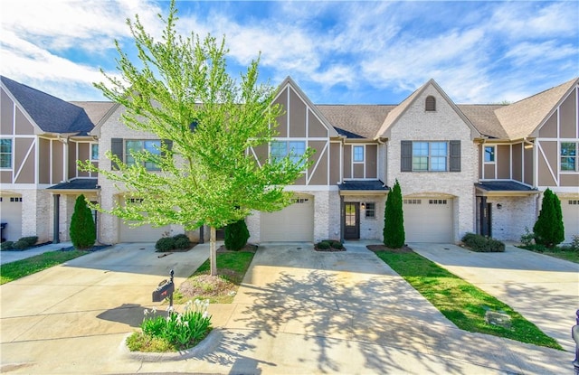 2046 Stephanie Ct, Auburn, AL 36830 - tudor home featuring driveway, an attached garage, and brick siding