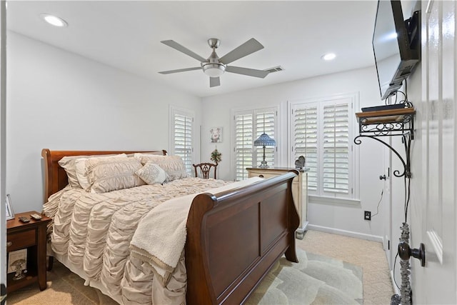 bedroom with ceiling fan and light carpet