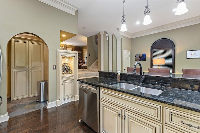 kitchen featuring dishwasher, sink, dark stone countertops, pendant lighting, and cream cabinetry