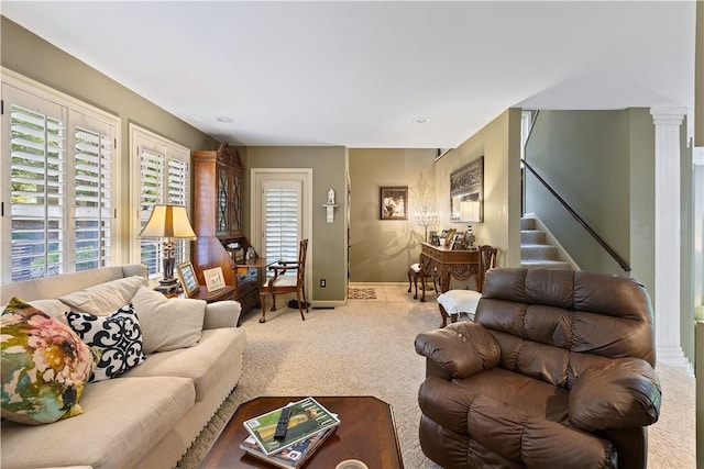 carpeted living room with ornate columns