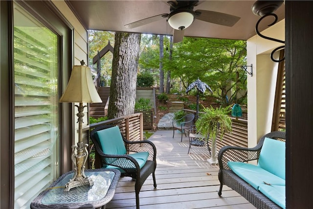 sunroom featuring ceiling fan