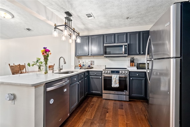1114 S College St Unit 302, Auburn, AL 36830 - kitchen with a textured ceiling, a sink, stainless steel appliances, a peninsula, and visible vents