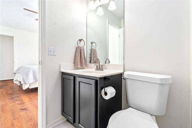 1114 S College St Unit 302, Auburn, AL 36830 - bathroom featuring wood finished floors, vanity, connected bathroom, and toilet