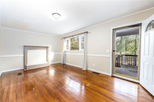 spare room with crown molding, wood-type flooring, and a wealth of natural light