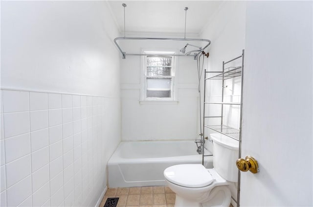 bathroom with tile walls, tile patterned flooring, toilet, and shower / bath combination