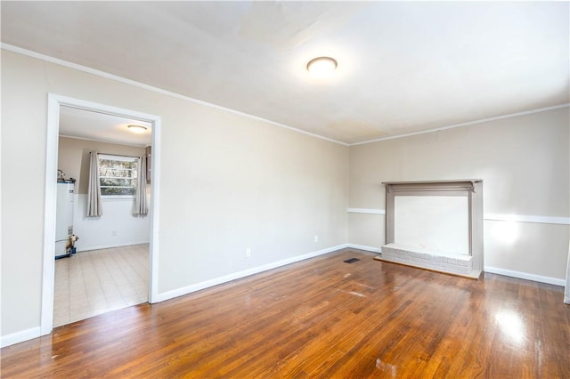 spare room with crown molding and dark hardwood / wood-style flooring