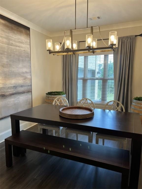 dining area with a chandelier, hardwood / wood-style flooring, and crown molding