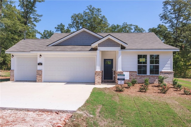 view of front facade with a front yard and a garage