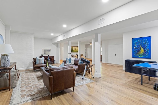 living room with visible vents, light wood-style flooring, and recessed lighting