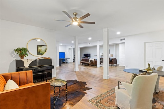 living area with a ceiling fan, recessed lighting, visible vents, and wood finished floors