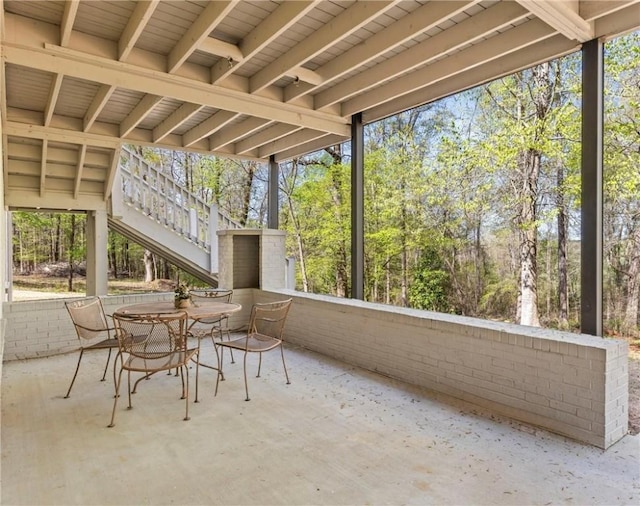 unfurnished sunroom featuring outdoor dining area