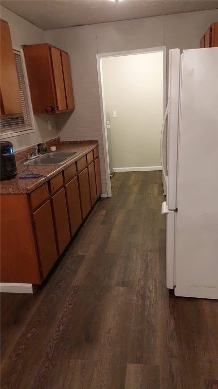 2102 Susie Cir, Tuskegee, AL 36083 - kitchen featuring freestanding refrigerator, dark wood-style flooring, and brown cabinetry