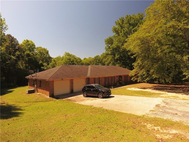 26 Arrowhead Rd, Phenix City, AL 36869 - view of front of house featuring driveway, a front lawn, a garage, and cooling unit