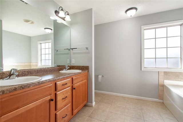 full bath with a sink, a bath, double vanity, and tile patterned flooring