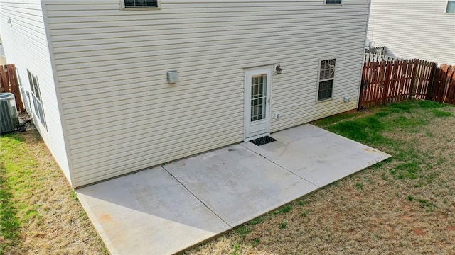 view of patio with central AC unit and fence