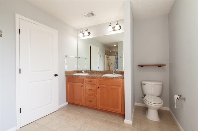 full bathroom with visible vents, toilet, a stall shower, a sink, and double vanity