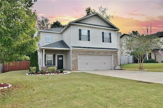 traditional-style home featuring a garage, concrete driveway, a front lawn, and fence