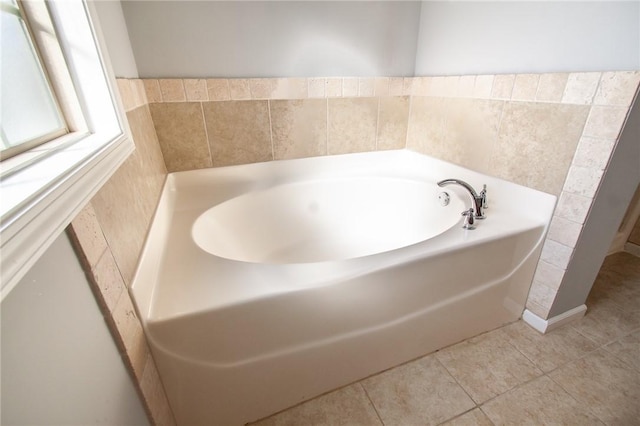 full bathroom with a garden tub and tile patterned flooring