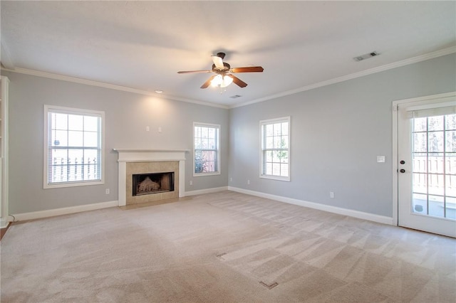 unfurnished living room featuring crown molding, a wealth of natural light, and light carpet