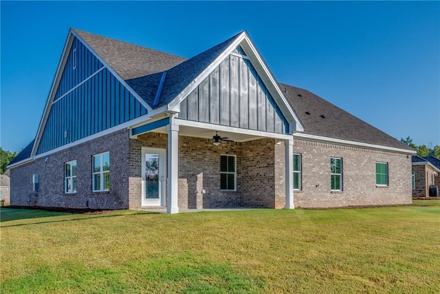 rear view of property with a yard and ceiling fan