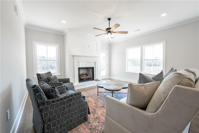 living room featuring ceiling fan, wood-type flooring, and ornamental molding