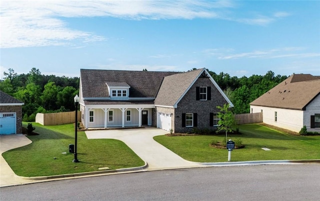 1534 Everly Dr, Opelika, AL 36801 - view of front of home featuring covered porch, driveway, an attached garage, and roof with shingles