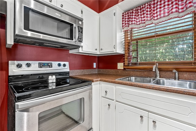 kitchen with white cabinetry, sink, and appliances with stainless steel finishes